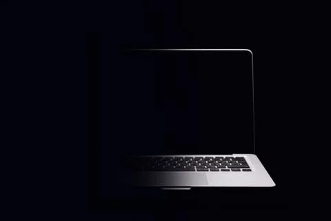 Portable modern silver computer on a black background. Stock Photos