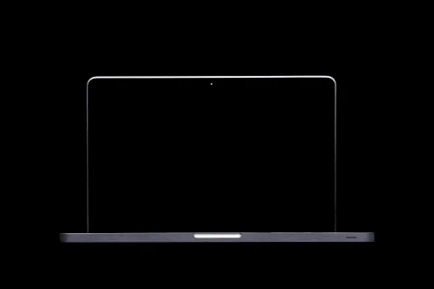Portable modern silver computer on a black background. Stock Photos