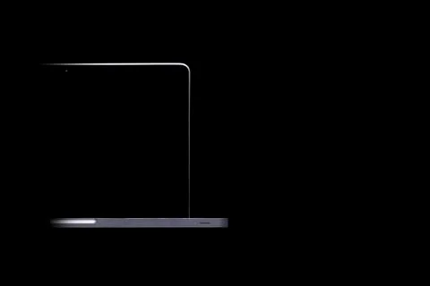 Portable modern silver computer on a black background. Stock Photos