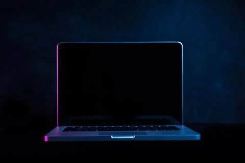 Portable modern silver computer on a black background. Stock Photos