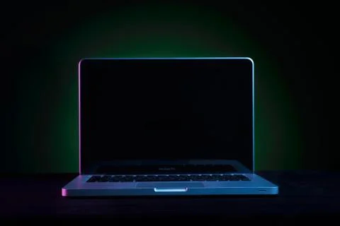 Portable modern silver computer on a black background. Stock Photos