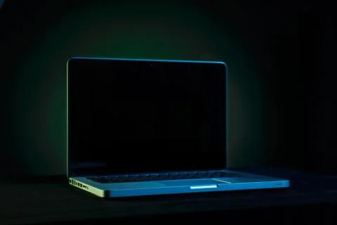 Portable modern silver computer on a black background. Stock Photos