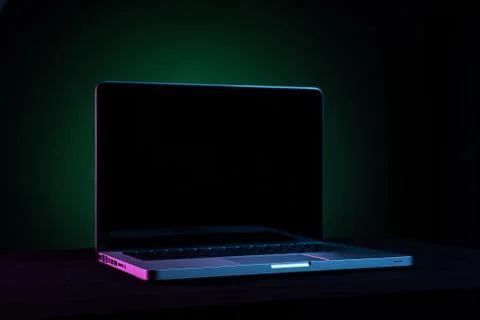 Portable modern silver computer on a black background. Stock Photos