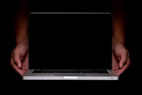 Portable modern silver computer on a black background. Stock Photos