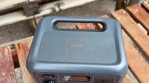Portable Power Station with Wireless Charging Pad on Wooden Bench Видео 332806409