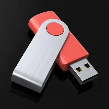 Portable red USB flash drive stick for workspace isolated on black background Stock Photos
