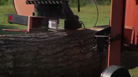 Portable sawmill cuts through log CU side shot Stock Footage 40472317