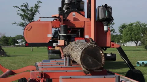 Portable sawmill makes first cut on log Stock Footage 40472325