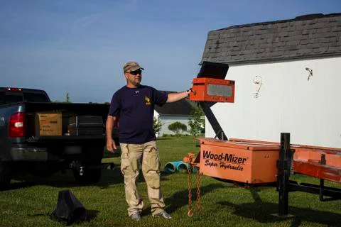 Portable sawmill operator at controls 스톡 사진