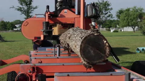 Portable sawmill steadies log for cutting Stock Footage 40472377