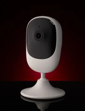 Portable security camera against dark background on table Stock Photos