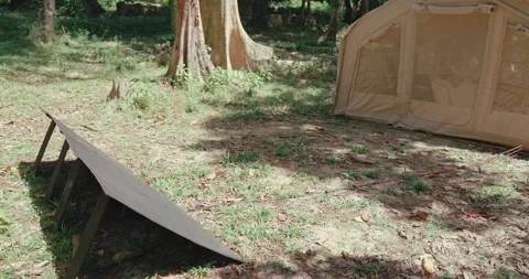 Portable solar panel charging camping tent in forest Видео 332322354