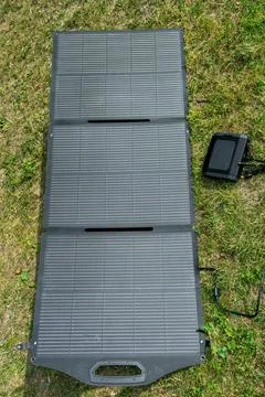 Portable solar panel charging portable power station outdoors. Renewable en.. Foto stock