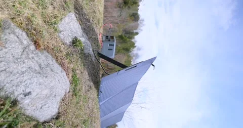 Portable solar panel charging power station outdoors. vertical video 스톡 동영상 336655882