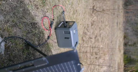 Portable Solar Power Station Connected to Solar Panel in Field for Outdoor Видео 336610454