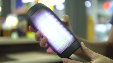 Portable speaker glows in hand. Stock Footage 91322691
