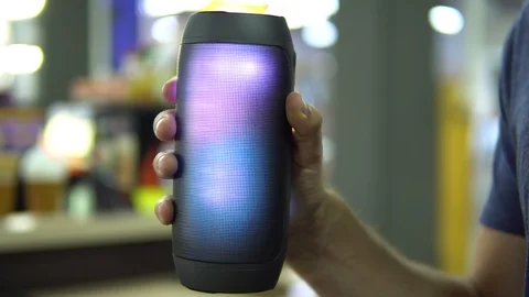 Portable speaker glows in hand. Stock Footage 91322891