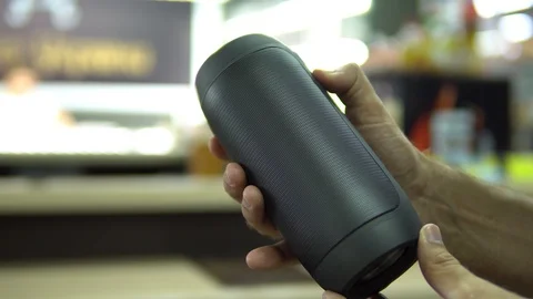 Portable speaker glows in hand. Stock Footage 91323483