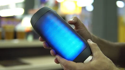 Portable speaker glows in hand. Stock Footage 91324284