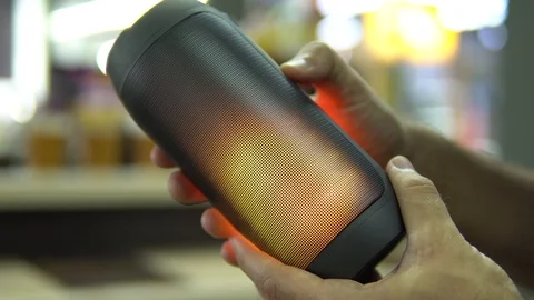 Portable speaker glows in hand. Stock Footage 91324348