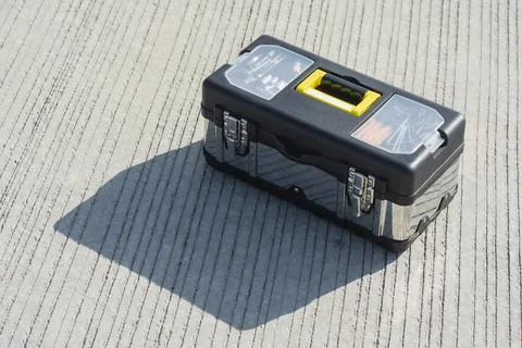 Portable toolbox with hardware tools placed on textured concrete surface ou.. Stock Photos