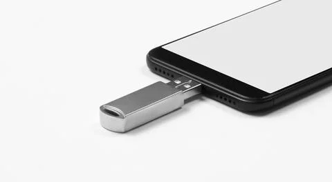 Portable USB flash drive connected to mobile phone isolated on white background Stock Photos