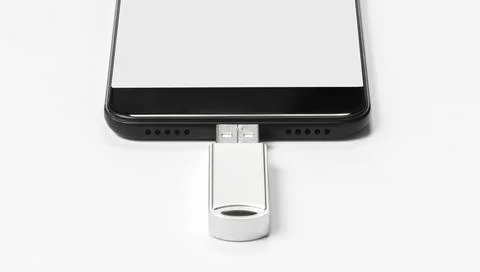 Portable USB flash drive connected to mobile phone isolated on white background Stock Photos