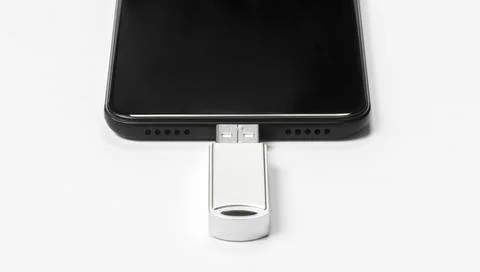 Portable USB flash drive connected to mobile phone isolated on white background Stock Photos