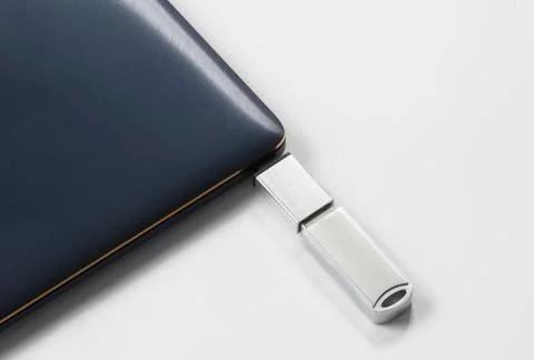 Portable USB flash drive connected to notebook isolated on white background Stock Photos