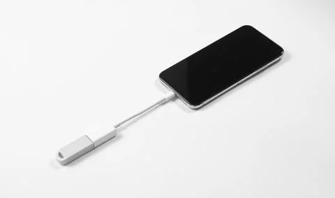 Portable USB flash drive connected to mobile phone isolated on white background Stock Photos