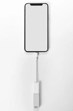 Portable USB flash drive connected to mobile phone isolated on white background Stock Photos