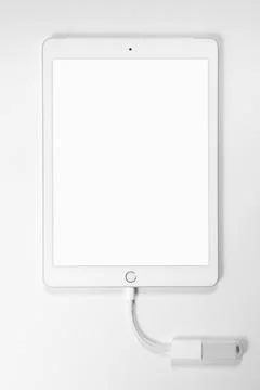 Portable USB flash drive connected to ipad isolated on white background. Mockup. Stock Photos