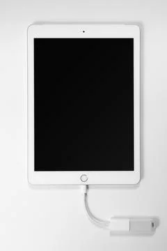 Portable USB flash drive connected to ipad isolated on white background. Mockup. Stock Photos