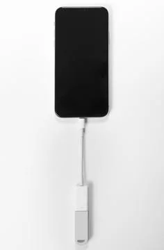 Portable USB flash drive connected to mobile phone isolated on white background Stock Photos