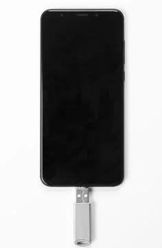 Portable USB flash drive connected to mobile phone isolated on white background Stock Photos