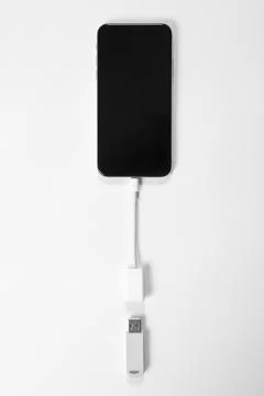 Portable USB flash drive connected to mobile phone isolated on white background Stock Photos