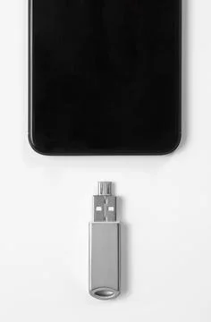 Portable USB flash drive connected to mobile phone isolated on white background Stock Photos