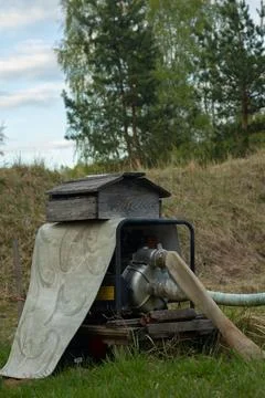 Portable water pump engine unit with hose Stock Photos