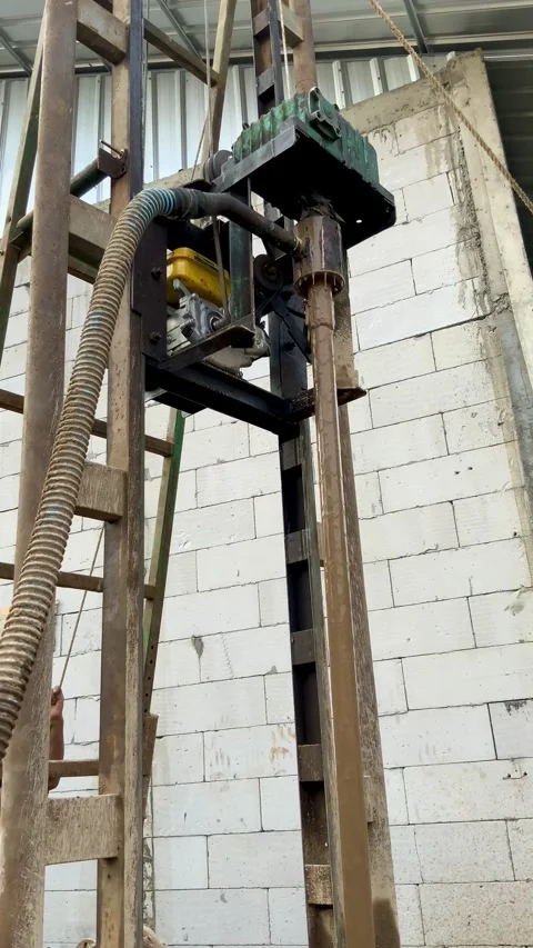 Portable water well drilling rig machine operating in a construction site Stock Footage 336097723