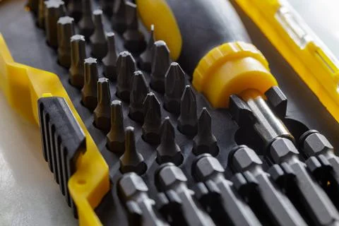 Portable yellow screwdriver with bits. construction tool Stock Photos
