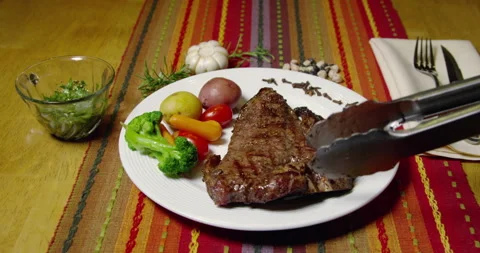 A Porterhouse Or T-bone Steak Served With Vegetables Stock Footage 243481440