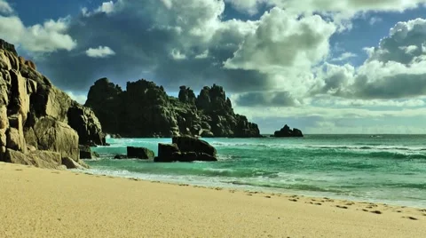 Porthcurno, Cornwall, view onto beach, rocks and clouds Stock Footage 49960593