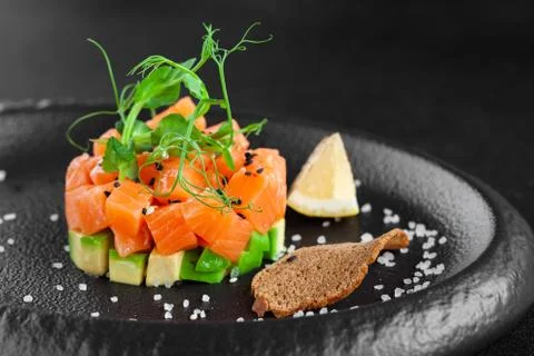 Portion of appetizer tartar made from chopped fresh salmon fish, avocado Stock Photos