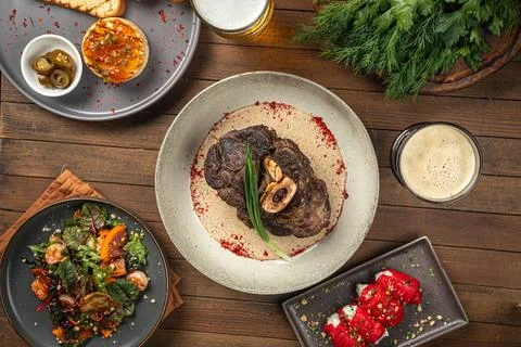 Portion of baked beef shank with pepper sauce Stock Photos