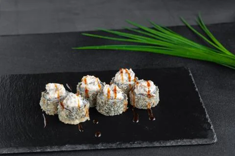 Portion of baked deep fried hot sushi rolls wrapped in nori Stock Photos