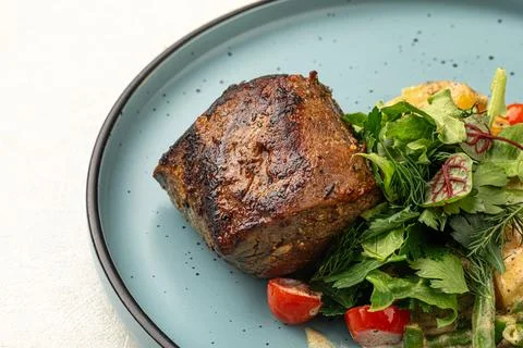 Portion of beef mignon steak with vegetables Stock Photos