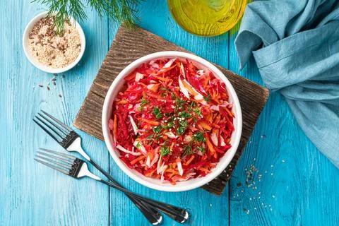 A portion of beet salad with cabbage and carrots in a white bowl. Stock Photos