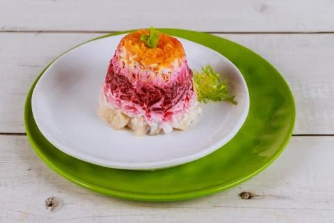 Portion beetroot salad with herring and vegetable. Stock Photos
