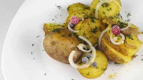 Portion of boiled potatoes.White plate rotates in a circle. Stock Footage 128701678