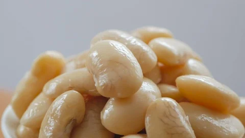 A portion of boiled white large beans rotates in the frame Stock Footage 102756628